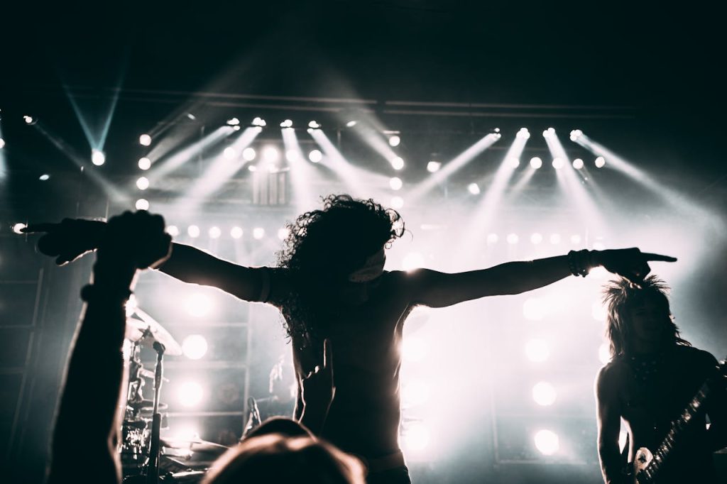 The Art of Drawing Readers In: Your attractive post title goes here Energetic rock band performance with striking stage lights and silhouettes.